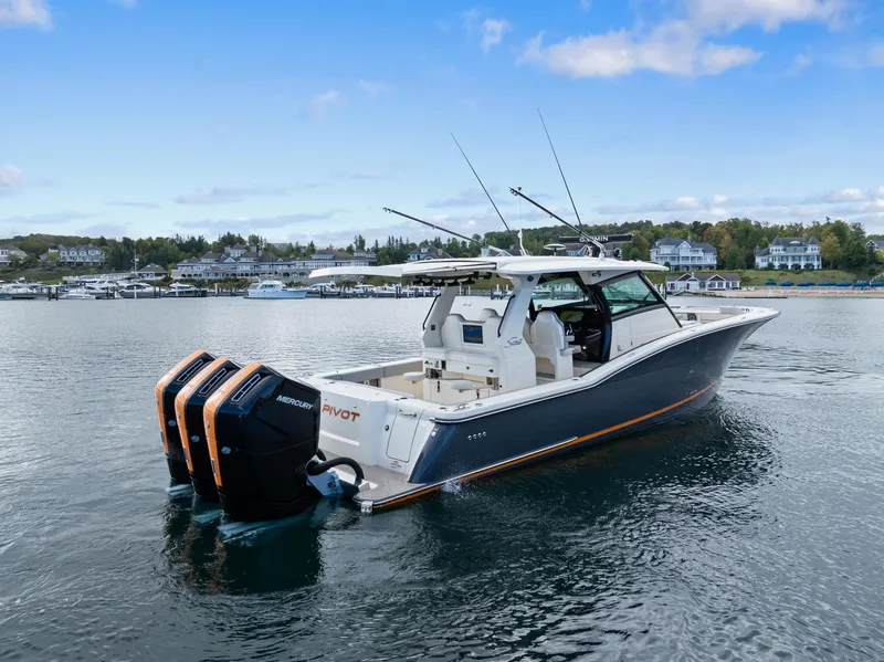 Slide: The Image of 2023 Scout 425 LXF boat with triple engines on a calm lake. - 20