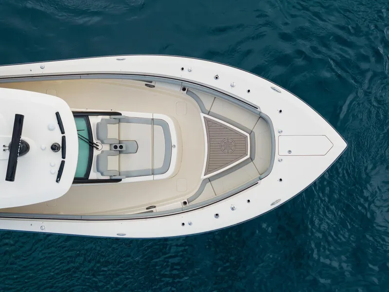Slide: The Image of 2023 Scout 425 LXF boat, aerial view, sleek design on blue water. - 22