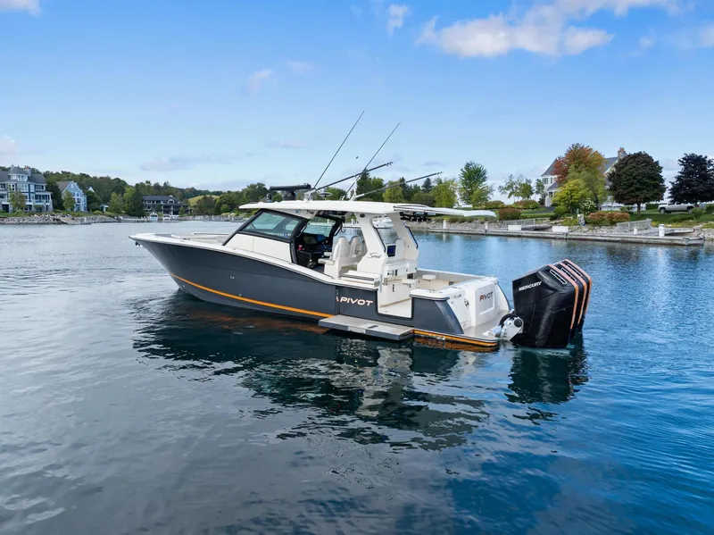 Slide: The Image of 2023 Scout 425 LXF boat on calm water, showcasing sleek design and powerful engines. - 25