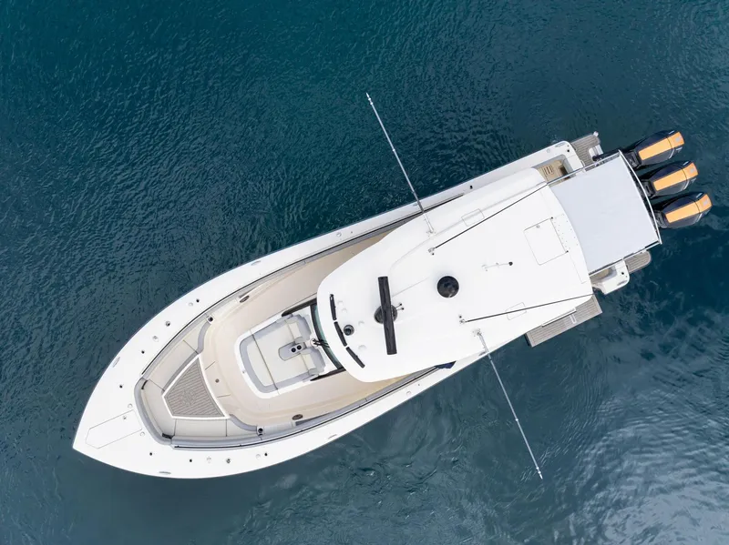 Slide: The Image of Aerial view of 2023 Scout 425 LXF luxury boat on clear blue water. - 28