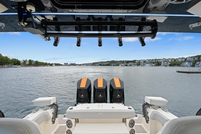 Slide: The Image of 2023 Scout 425 LXF boat with triple engines on a scenic waterway. - 34