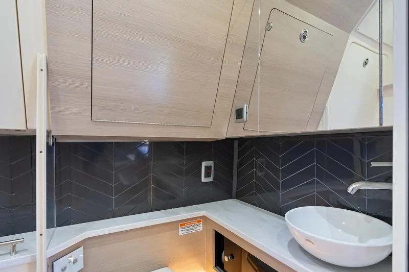 Slide: The Image of 2023 Scout 425 LXF interior with modern sink and sleek cabinetry design. - 39