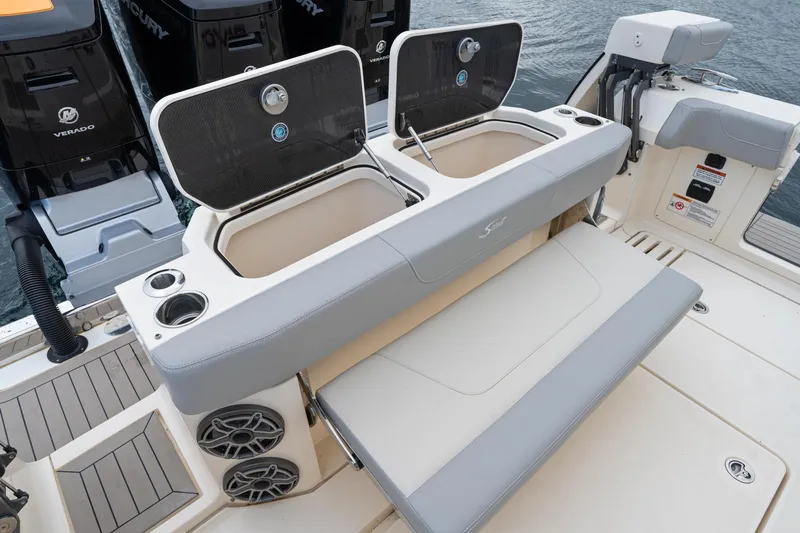 Slide: The Image of 2023 Scout 425 LXF boat with open storage compartments and seating area. - 44