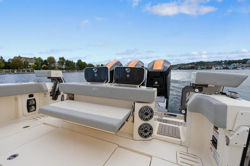 Slide: The Image of 2023 Scout 425 LXF boat with seating and engines on a calm waterway. - 46