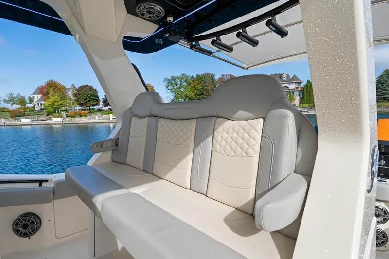 Slide: The Image of 2023 Scout 425 LXF boat interior with luxurious seating by the water. - 48