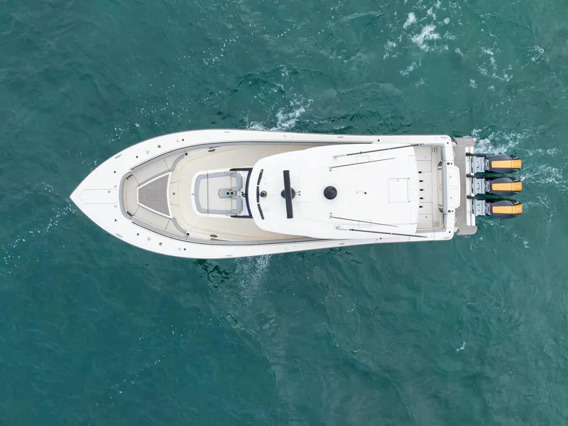 Slide: The Image of Aerial view of 2023 Scout 425 LXF boat on turquoise water. - 6