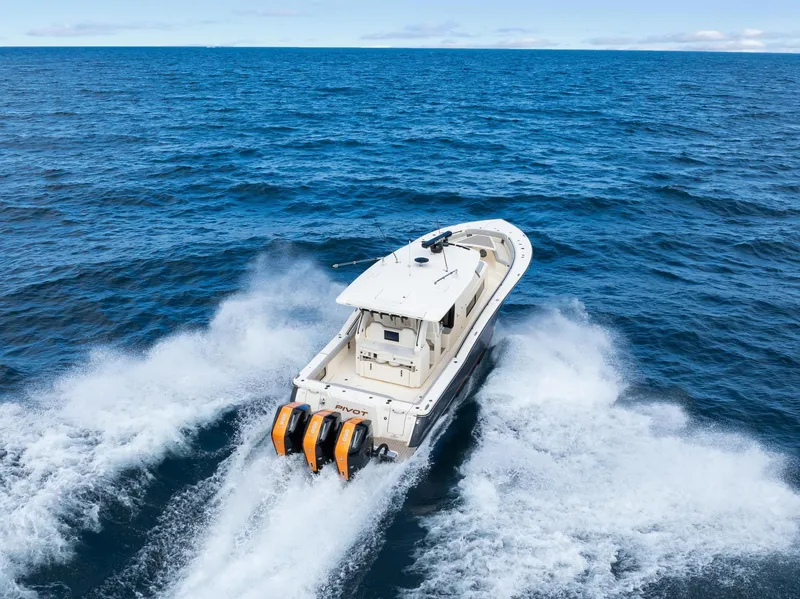 Slide: The Image of 2023 Scout 425 LXF boat cruising on open ocean waters. - 8