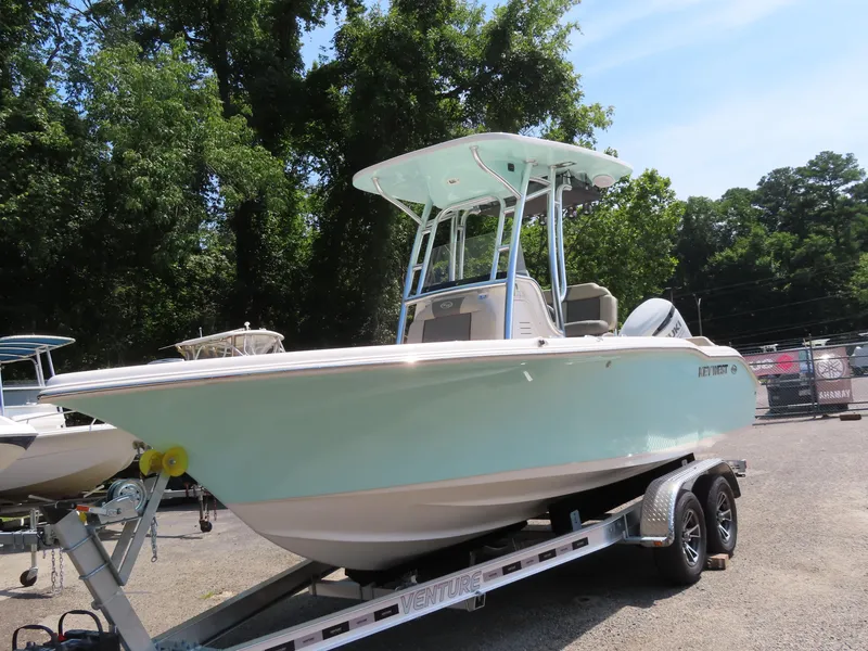 Slide: The Image of 2025 Key West 219 FS boat on trailer, parked outdoors. - 10