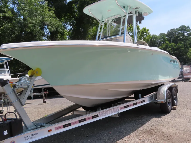 Slide: The Image of 2025 Key West 219 FS boat on trailer, parked outdoors. - 11