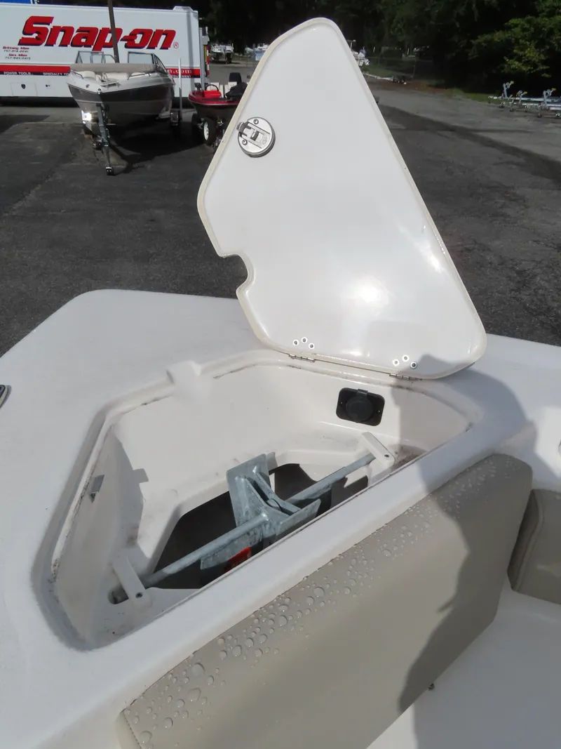 Slide: The Image of 2025 Key West 219 FS boat anchor compartment open, showing storage space. - 17