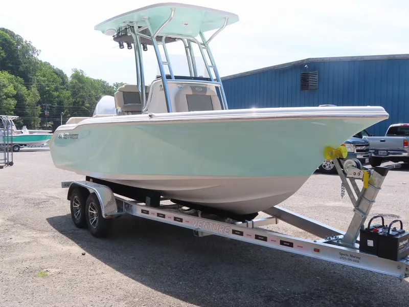 Slide: The Image of 2025 Key West 219 FS boat on trailer in parking lot. - 2