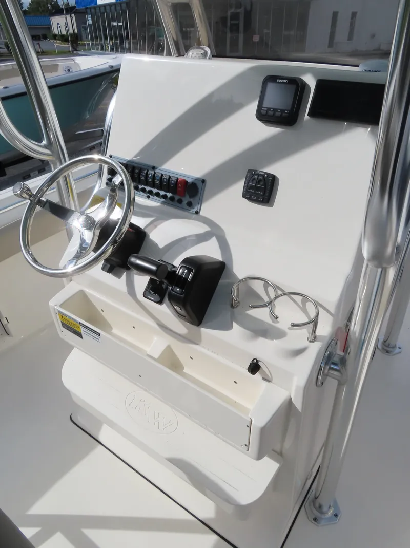 Slide: The Image of 2025 Key West 219 FS boat console with steering wheel and controls. - 21