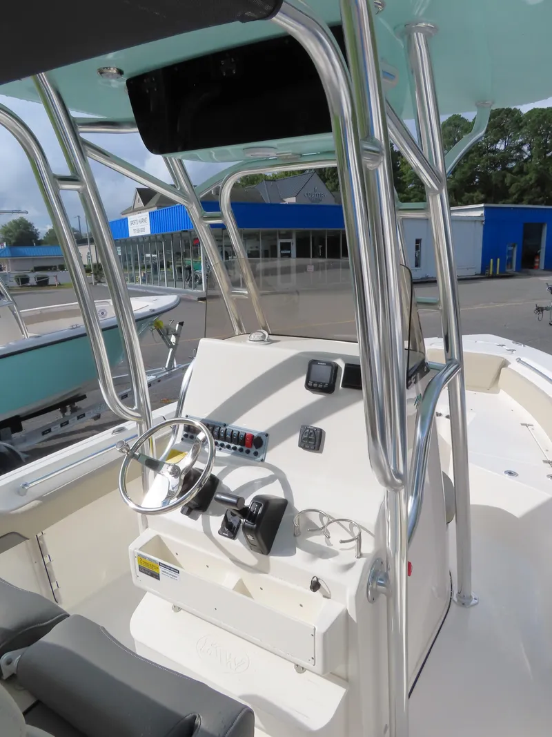 Slide: The Image of 2025 Key West 219 FS boat interior with steering console and seating. - 23