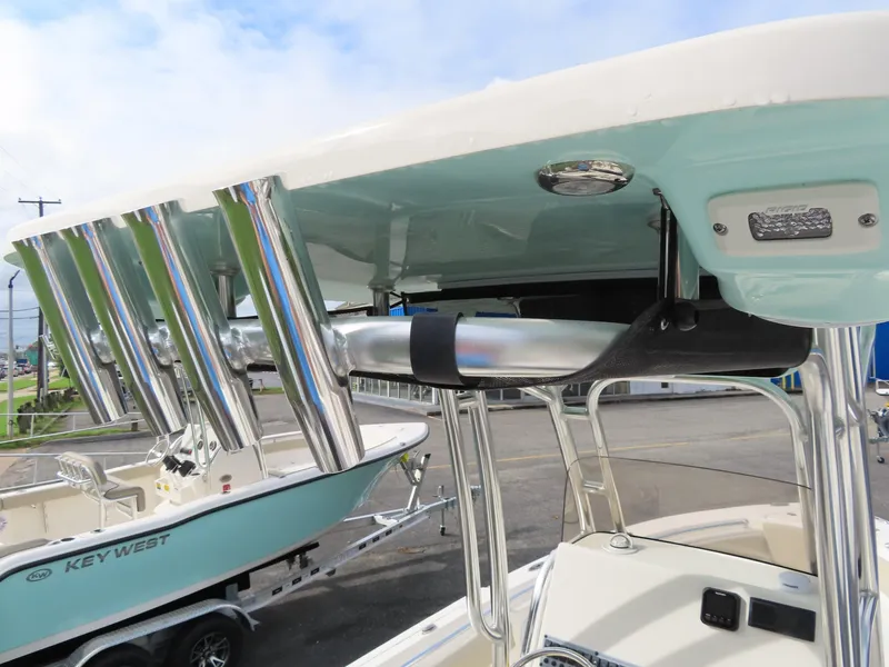 Slide: The Image of 2025 Key West 219 FS boat with rod holders and T-top detail. - 26