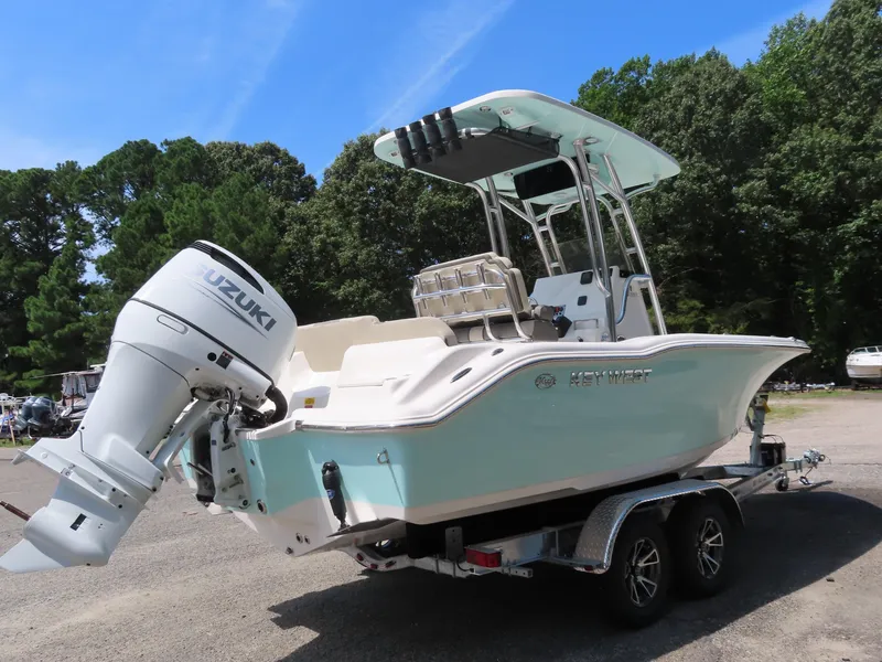 Slide: The Image of 2025 Key West 219 FS boat with Suzuki outboard motor on trailer. - 30