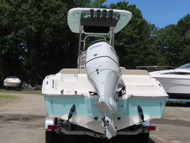 Slide: The Image of 2025 Key West 219 FS boat with outboard motor, parked outdoors. - 31