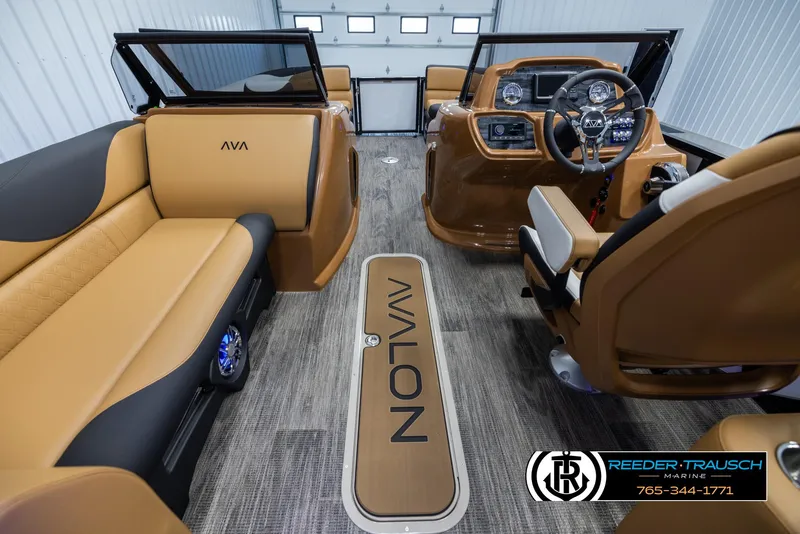 Slide: The Image of 2025 Avalon LSZ EL boat interior with tan seating and modern dashboard. - 17