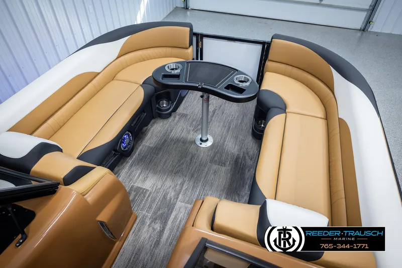 Slide: The Image of 2025 Avalon LSZ EL pontoon boat interior with tan seating and central table. - 21