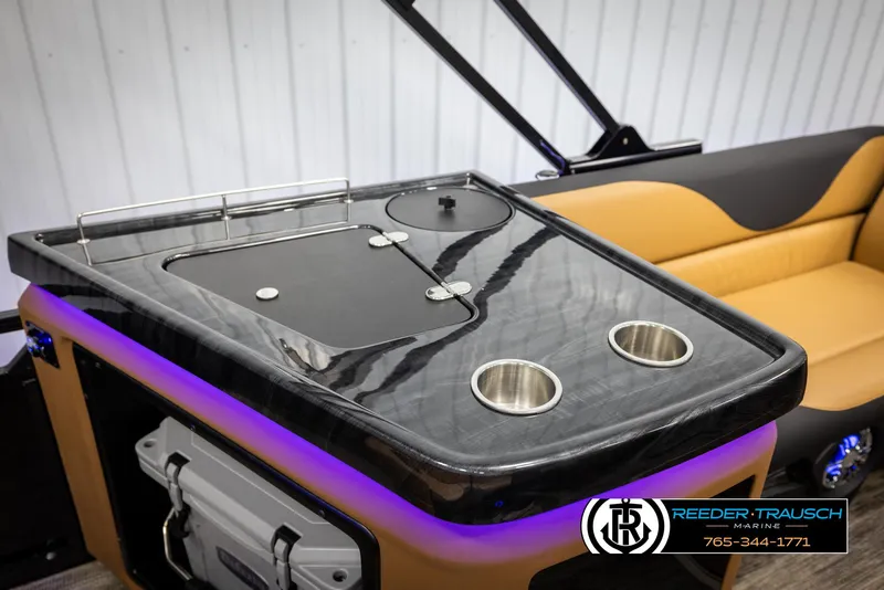 Slide: The Image of 2025 Avalon LSZ EL boat interior with sleek bar area and cup holders. - 24