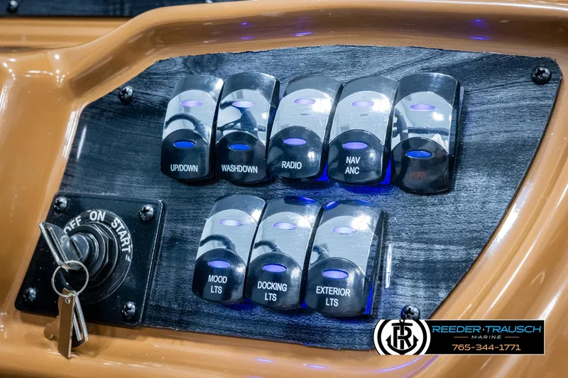 Slide: The Image of Control panel of 2025 Avalon LSZ EL boat with labeled switches and ignition key. - 34