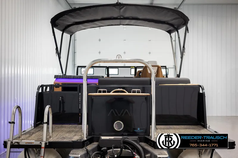 Slide: The Image of 2025 Avalon LSZ EL pontoon boat in a showroom with canopy and ladder. - 7