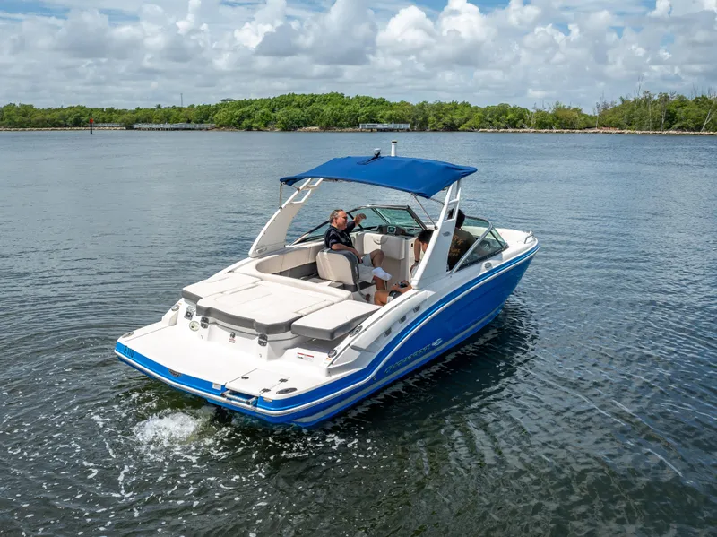 Slide: The Image of 2017 Chaparral 227 SSX boat cruising on a calm lake under a cloudy sky. - 10