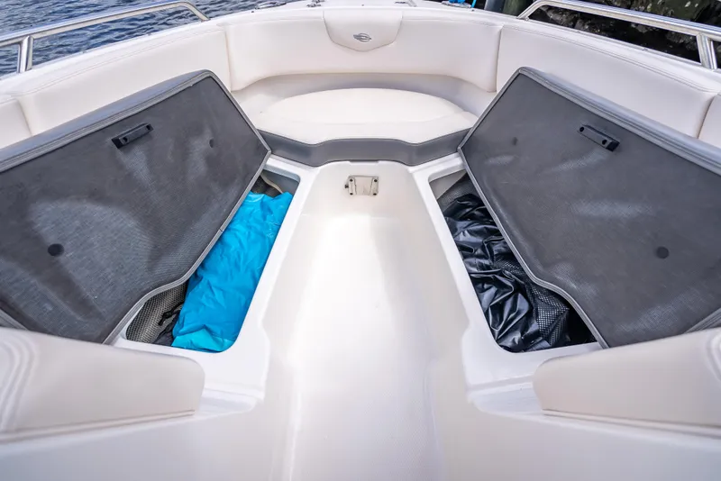Slide: The Image of 2017 Chaparral 227 SSX boat interior with open storage compartments and seating. - 26
