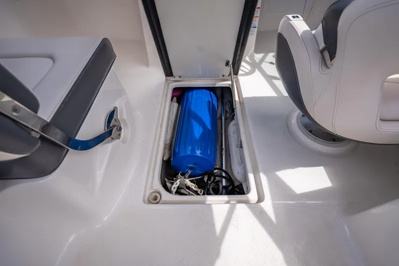 Slide: The Image of Storage compartment in 2017 Chaparral 227 SSX boat with blue equipment inside. - 29