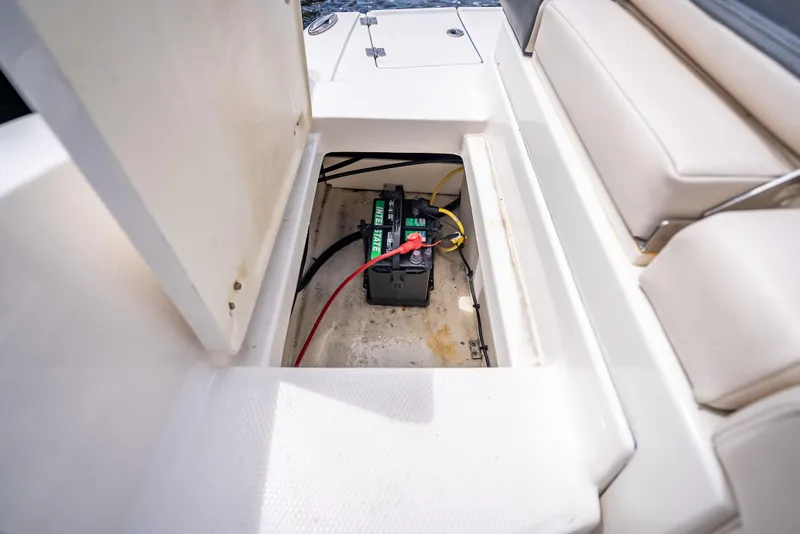 Slide: The Image of Battery compartment of 2017 Chaparral 227 SSX boat, featuring a marine battery. - 33