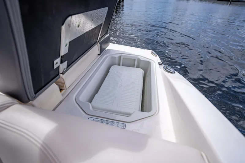 Slide: The Image of Open storage compartment on 2017 Chaparral 227 SSX boat, near water. - 36