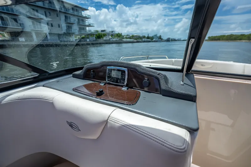 Slide: The Image of 2017 Chaparral 227 SSX boat dashboard with water view and modern controls. - 39