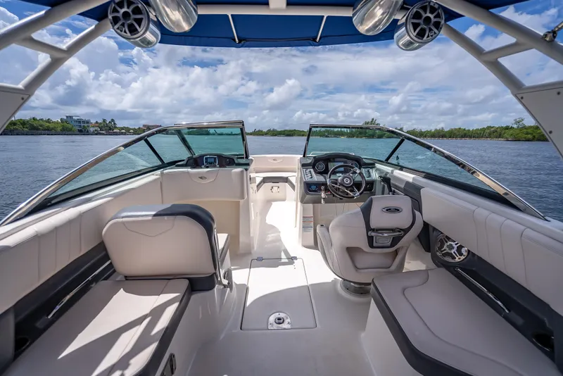 Slide: The Image of 2017 Chaparral 227 SSX boat interior with luxurious seating and modern dashboard on a sunny day. - 41