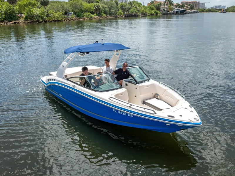 Slide: The Image of 2017 Chaparral 227 SSX boat cruising on a calm river with passengers onboard. - 7