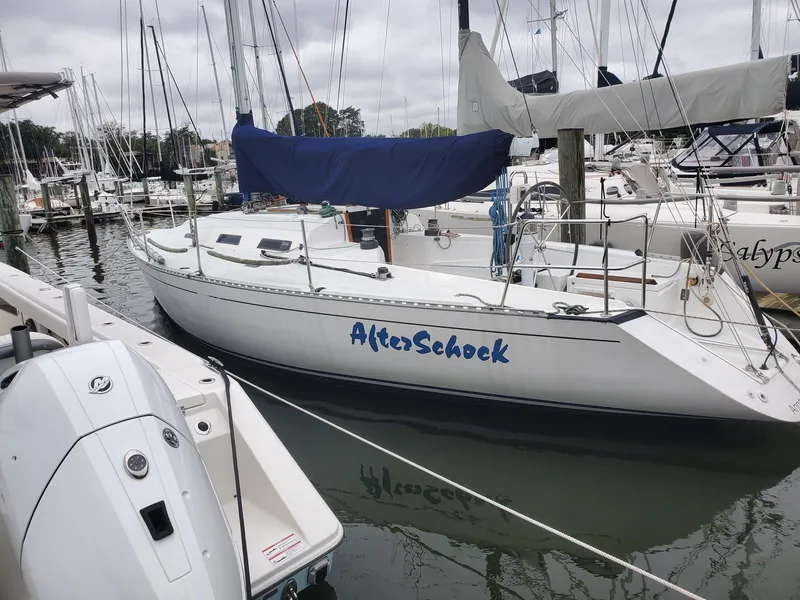 The Image of 2001 Schock 35 sailboat docked in marina, featuring blue cover and "AlterSchock" name. - 0