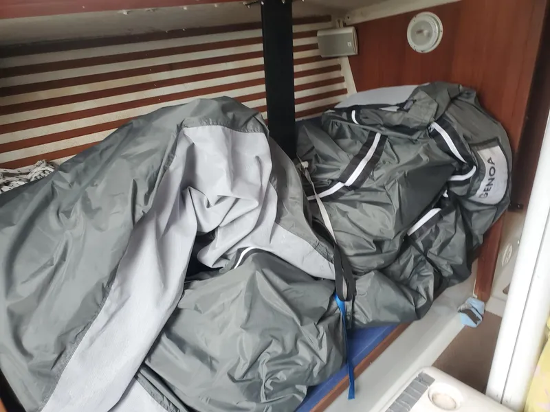 Slide: The Image of Navigation station in a 2001 Schock 35 sailboat with radio equipment and safety gear. - 13