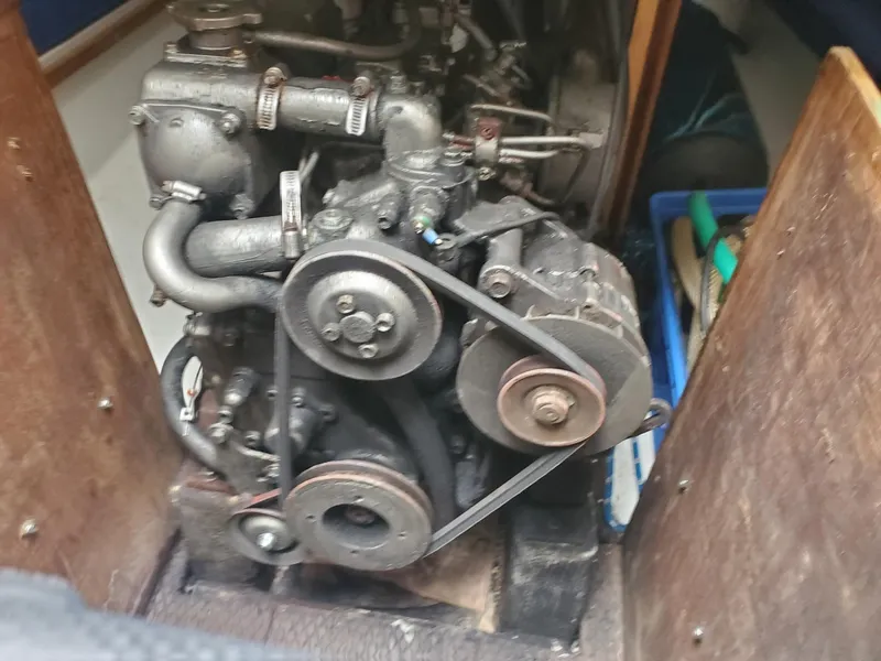 Slide: The Image of Engine of a 2001 Schock 35 sailboat, featuring visible belts and components. - 23