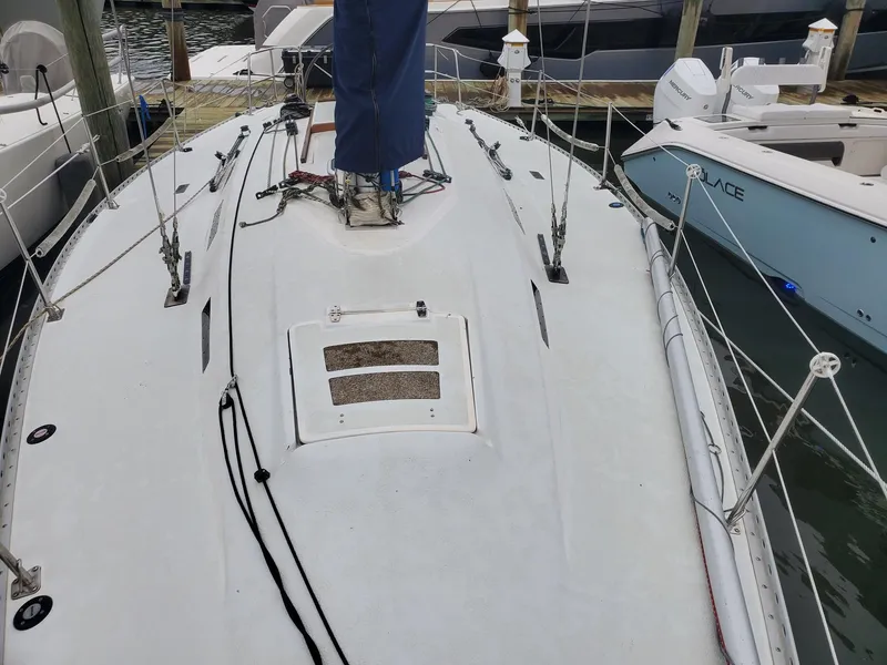 Slide: The Image of 2001 Schock 35 sailboat named "AfterSchock" on stands, showing hull and keel. - 3