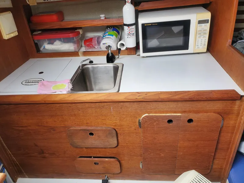 Slide: The Image of 2001 Schock 35 sailboat deck with ropes and winch by the water. - 8