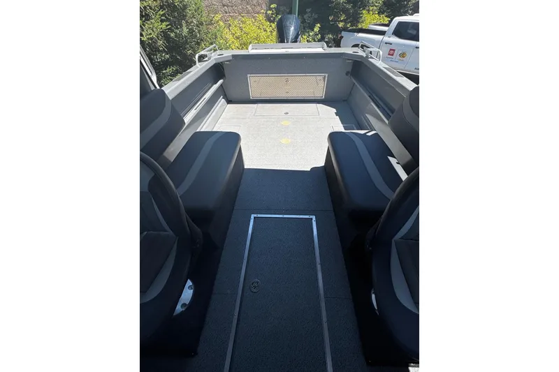Slide: The Image of 2024 Spartan 215 Athens boat interior with seating and spacious deck. - 12