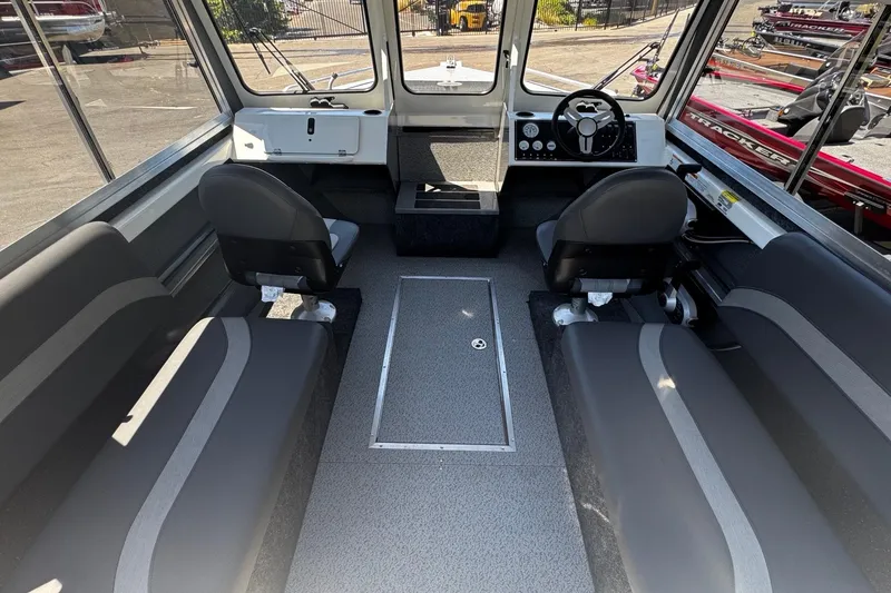 Slide: The Image of 2024 Spartan 215 Athens boat interior with seating and steering console. - 10