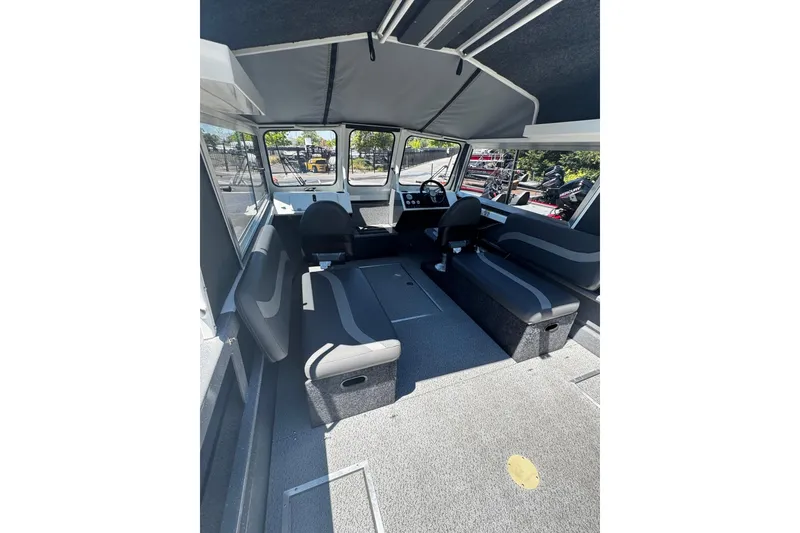 Slide: The Image of 2024 Spartan 215 Athens boat interior with seating and steering console. - 14