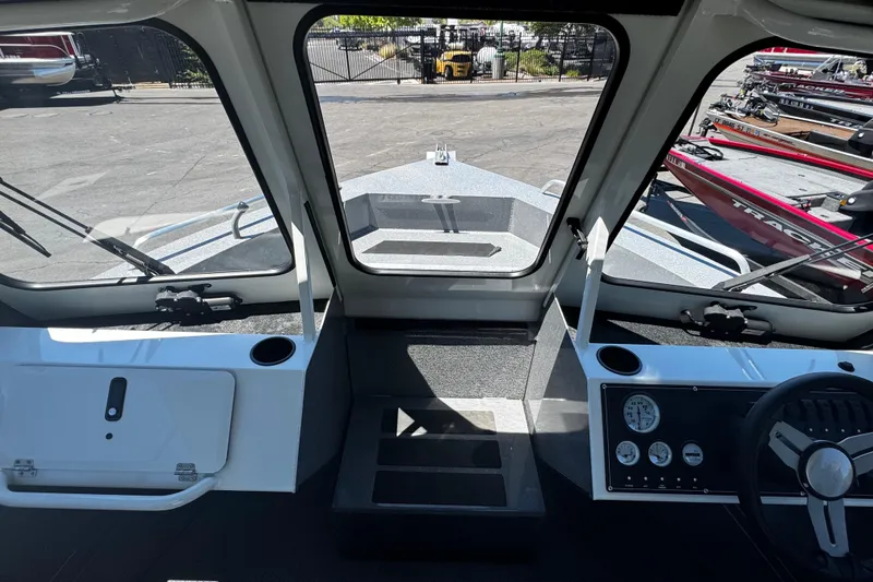 Slide: The Image of 2024 Spartan 215 Athens boat interior with dashboard and steering wheel. - 8