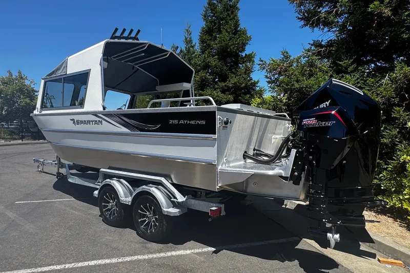 Slide: The Image of 2024 Spartan 215 Athens boat on trailer, featuring sleek design and powerful outboard motor. - 1