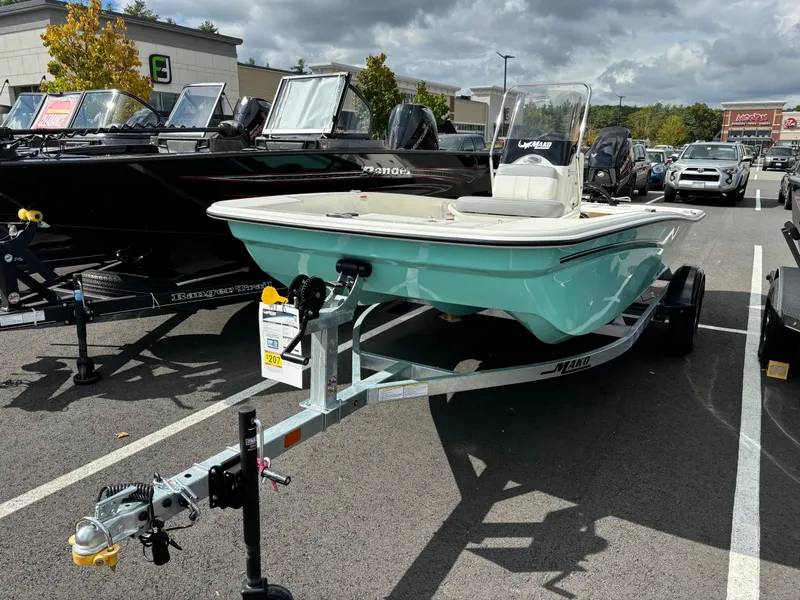 Slide: The Image of 2025 Mako Pro Skiff 15 CC boat on trailer in parking lot. - 3
