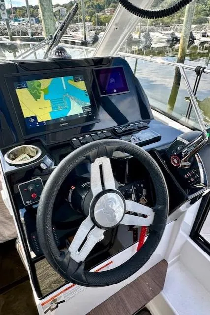 Slide: The Image of 2024 Beneteau Antares 9 helm with navigation display and steering wheel. - 11