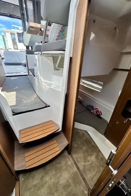 Slide: The Image of 2024 Beneteau Antares 9 interior with modern design and wooden accents. - 13