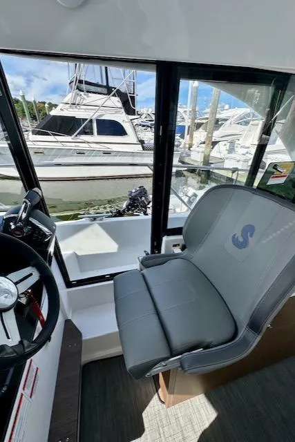 Slide: The Image of Interior view of 2024 Beneteau Antares 9 boat with helm and seating. - 14