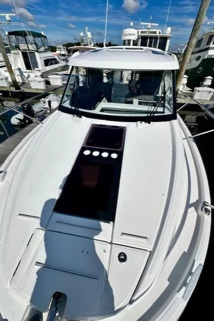 Slide: The Image of 2024 Beneteau Antares 9 docked, showcasing sleek design and spacious deck. - 18