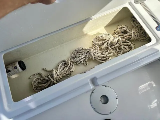 Slide: The Image of Storage compartment with rope on a 2024 Beneteau Antares 9 boat. - 21