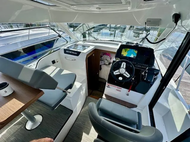 Slide: The Image of Interior of 2024 Beneteau Antares 9 boat, featuring helm and seating area. - 5